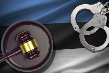 Estonia flag with judge mallet and handcuffs in dark room. Concept of criminal and punishment,...
