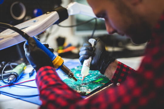 IT engineer technician repairing computer in electronics service shop