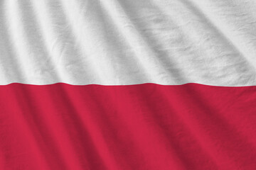 Poland flag with big folds waving close up under the studio light indoors. The official symbols and...