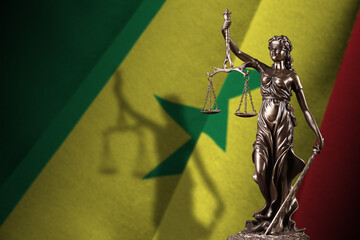 Senegal flag with statue of lady justice and judicial scales in dark room. Concept of judgement and...