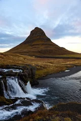 Papier Peint photo autocollant Kirkjufell Vertical of a waterfall and the Kirkjufell hill in Iceland.