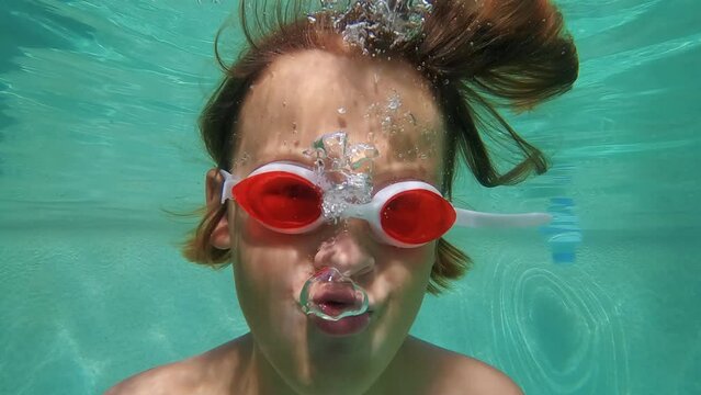 Slow motion - teenager in an underwater pool