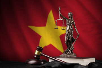 Vietnam flag with statue of lady justice, constitution and judge hammer on black drapery. Concept...
