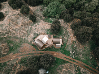 aerial view image taken with a drone of the pretty lonely little huts by the road amidst the...