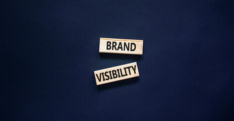 Brand visibility symbol. Concept words Brand visibility on wooden blocks. Beautiful black table black background. Business branding and brand visibility concept. Copy space.