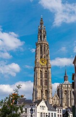 Vertical shot of the Cathedral of Our Lady of Antwerp against a blue sky on a sunny day in Belgium