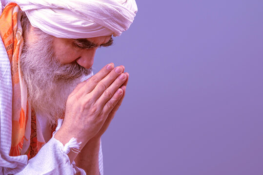 Old man praying. Senior man in a turban is associated with a Hindu, Jain, Buddhist.