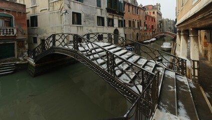 Fototapeta na wymiar Small footbridge over the canal in Venice, Italy