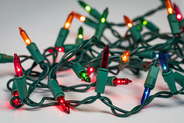 Christmas string lights with bad bulb. Holiday lighting repair, safety and decoration concept.