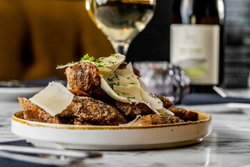 Appetizing shot of roasted beef with cheese slices and herbs  over a marble table