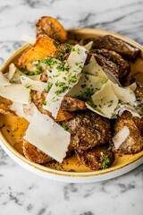 Vertical shot of roasted beef with cheese slices and herbs over a marble table
