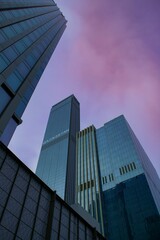 Fototapeta na wymiar Low angle of modern skyscrapers against a purplish sky