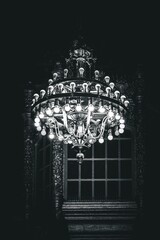 Beautiful classic chandelier on a ceiling, vertical shot