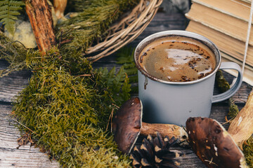 Old books and cup of coffee on dark wooden background