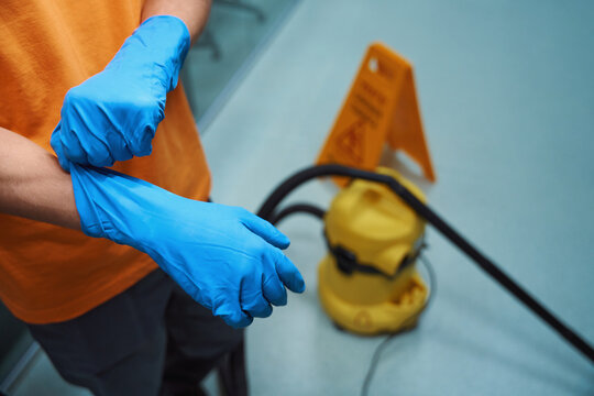 Professional cleaner using proper gloves during their work