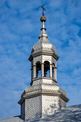 General view and architectural details of the wooden belfry and the neo-Gothic Catholic church of Saint John the Baptist built in 1874 in the village of Żmijewo Kościelne in Masovia, Poland.
