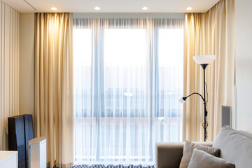 large window in a room with curtains and tulle