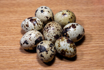 A close-up of many quail eggs