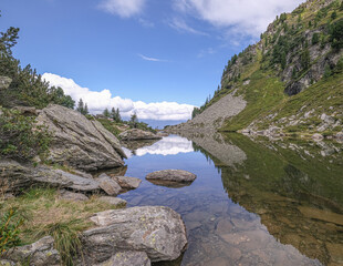 Fototapeta premium View of Spiegelsee [Mirror lake] as seen on the trial from Rippetegg summit back to Rieteralm, Schladming, Styria, Austria