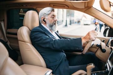 Gray-haired executive car driver