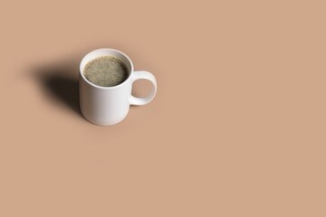 white cup of coffee and a mug of milk on a light background.
