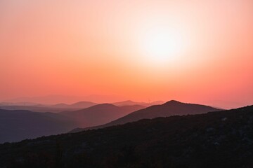 Scenic shot of mountain silhouettes of Mali Kozjak under a reddish sky in Dalmatia, Croatia