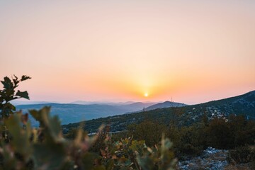 Scenic shot of the setting sun on the horizon of Mali Kozjak in Dalmatia, Croatia
