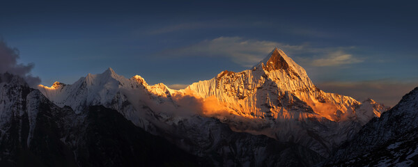 Fototapeta na wymiar Panoramic view of the Mt. Machapuchare at sunset from Annapurna base camp. Himalaya mountains, Nepal.