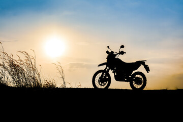Fototapeta na wymiar Motocross on a beautiful light mountain independent adventure tourism concept