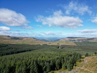 Aerial view of Meikle Bin Hill, Carron Valley, and nearby green land in rural Scotland