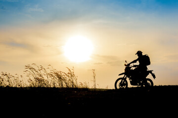 Fototapeta na wymiar man with motocross beautiful light mountain independent adventure tourism concept