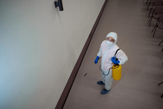 Certified Janitor In Protective Suit Preparing For Disinfective Fogging