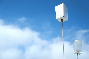 Low-angle of pole boxes  with the cloudy sky background