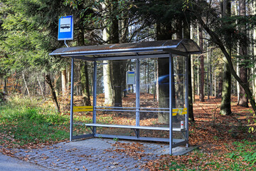 WYSOKA, POLAND - OCTOBER 30, 2022: Vintage bus stop on a country road in the deep forest.