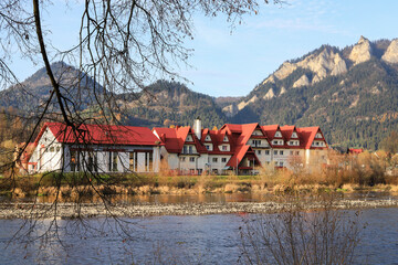 SROMOWCE NIZNE, POLAND - NOVEMBER 09, 2022: View of the buildings in the town and mountains behind...