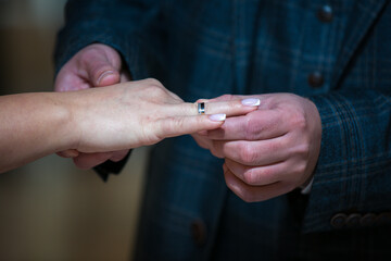 The bride and groom exchange wedding rings in the church during a Christian wedding ceremony