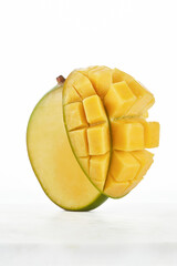 Close up of fresh ripe mango fruit and mango cubes on a white background. Mango. Selective focus