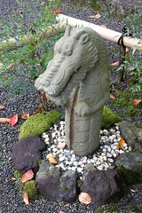Fototapeta na wymiar Concrete dragon statue in the garden of Saikyo-ji Buddhist temple in Shiga, Japan