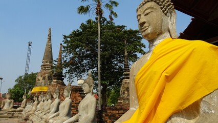 Buddha statue with a temple in the background in Thailand