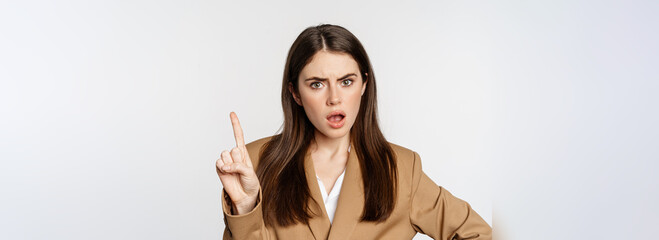 Disappointed lady boss, business woman shaking finger taboo sign, decline, prohibit something,...