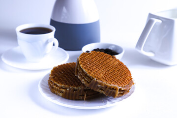 A portion of rounded waffle cake on a white plate. Shallow depth of field