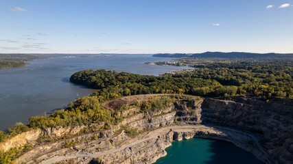 Aerial view over a rock quarry with turquoise colored water in upstate, NY on a sunny day