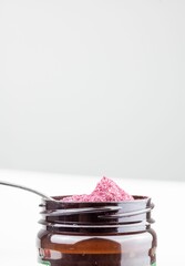 Jar of beetroot powder isolated on white