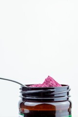 Jar of beetroot powder isolated on white