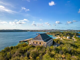 Aerial shot of a coastline with houses and greenery near Caracas Bay