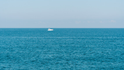 White boat on the horizon of the sea, Batumi