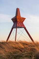 Fototapeta premium Red Sea Mark in Loekken, North Jutland, Denmark - vertical shot