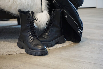 winter coat white fur black boot leather winter shoes messy home wet shoes cold ice snowy outside chaos home mess laces shoes on floor busy day winter cold fashion big black boots womens fashion
