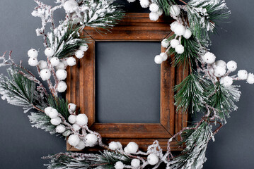 Christmas decorations and wooden frame. Fir branch on a gray background. copy space