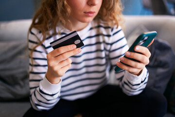 Worried woman with smartphone, debit card has problem paying bill, forgot banking app password....